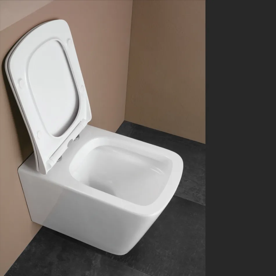 Inodoro suspendido con asiento cerámico de cierre suave y diseño moderno - Giunco viadurini
